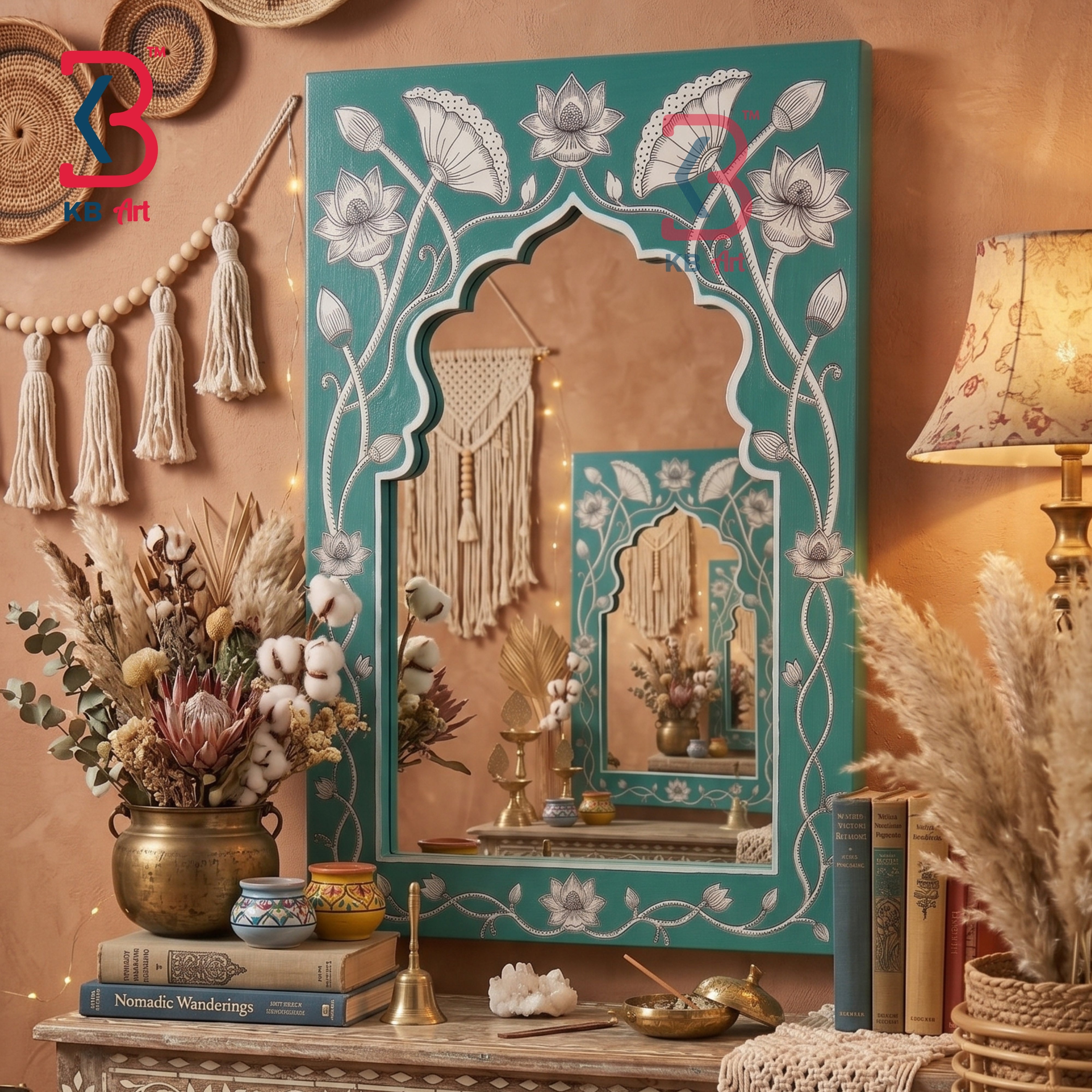 A decorative teal and white Moroccan-style arched mirror with floral inlay, displayed on a wooden console table in a warm boho room setting with dried flowers, books, and a lamp.